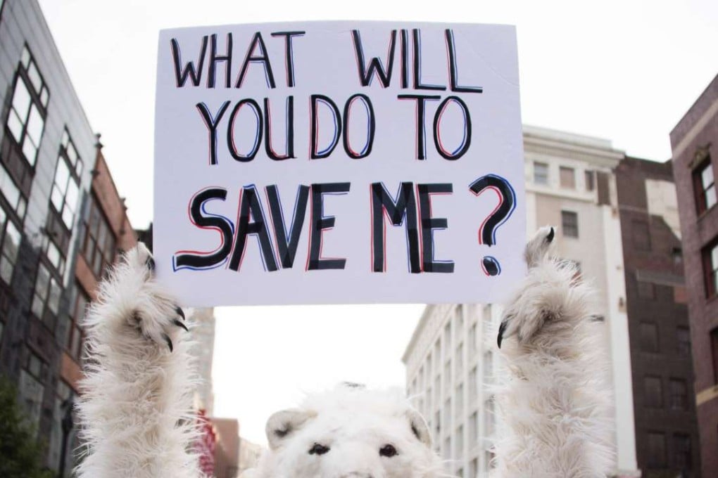 An environmental activist holds up a placard in Cleveland, Ohio, near the Republican National Convention site on July 18. Photo: AFP