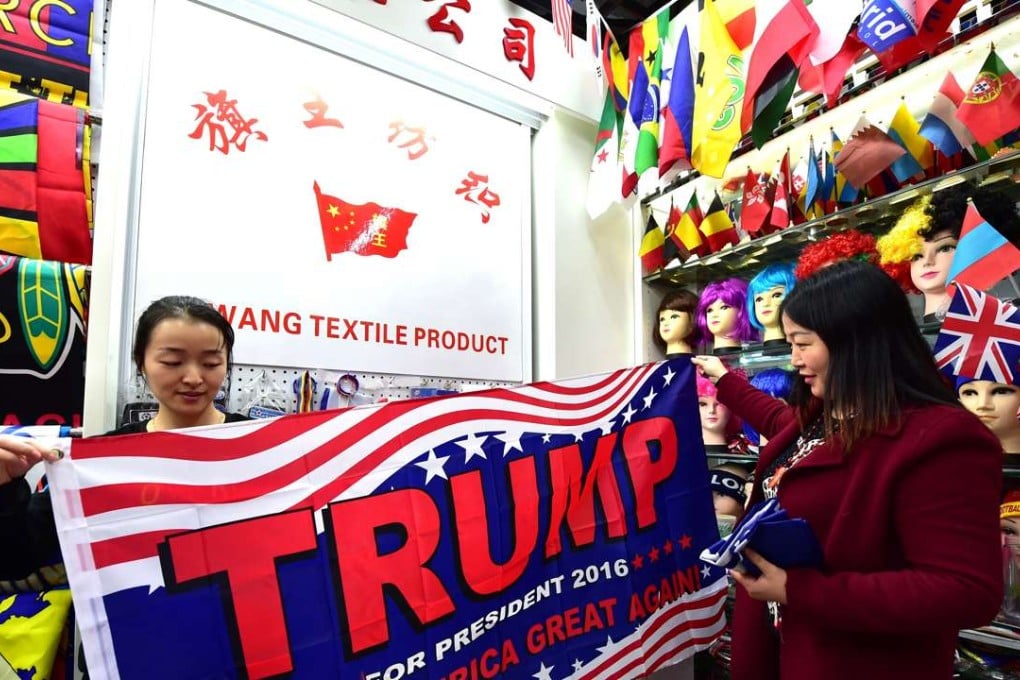 A shop assistant with a pro-Trump banner at the China Yiwu International Trade City. Photo: AFP