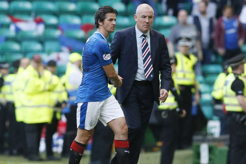 Rangers manager Mark Warburton with Joey Barton at the end of the game against rivals Celtic. Photo: Reuters