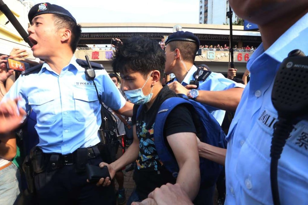 A protester against parallel trading is led away in Sheung Shui. This is an example of tension between Hongkongers and mainland people. Photo: David Wong