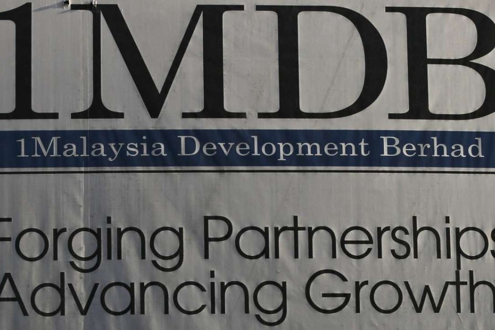 A man walks past a billboard of construction site 1Malaysia Development Berhad (1MDB) flagship Tun Razak Exchange in Kuala Lumpur in 2015. Photo: EPA