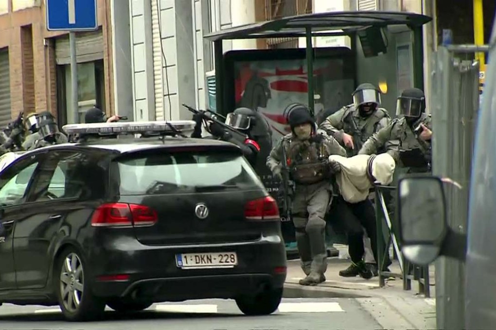 Armed Belgian police apprehend Salah Abdeslam, one of the main suspects in the Paris attacks. Photo: Reuters