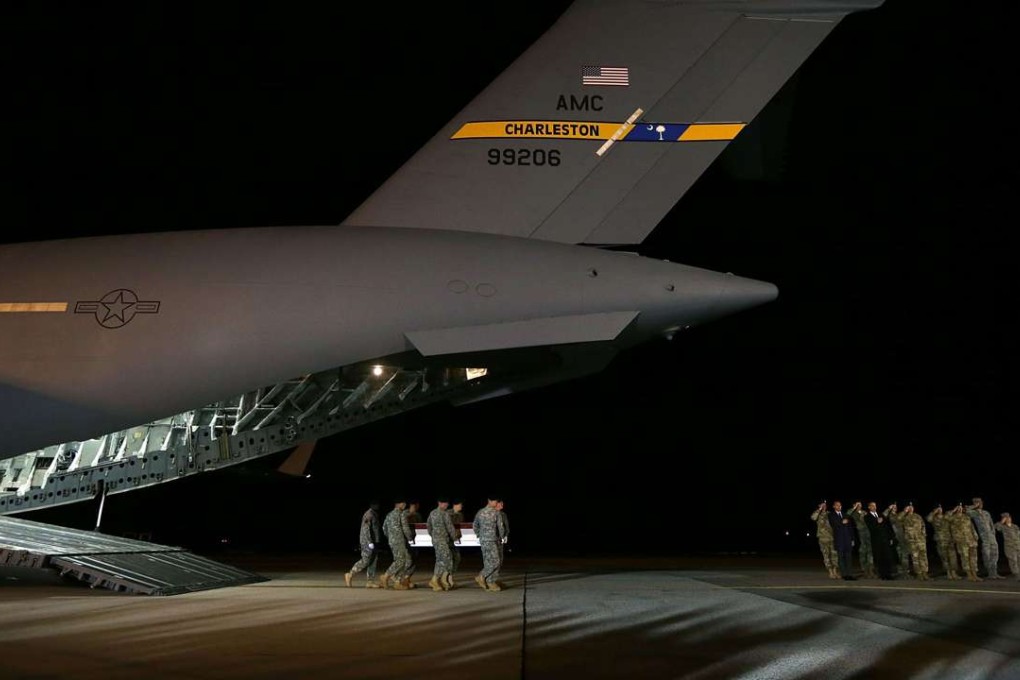 Members of the US Army carry a coffin holding the remains of one of the Special Forces team killed in Jordan. Photo: AFP