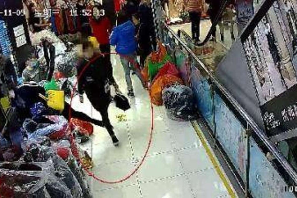 The woman is seen on surveillance footage leaving the store wearing a black coat and black pants. Photo: SCMP Pictures