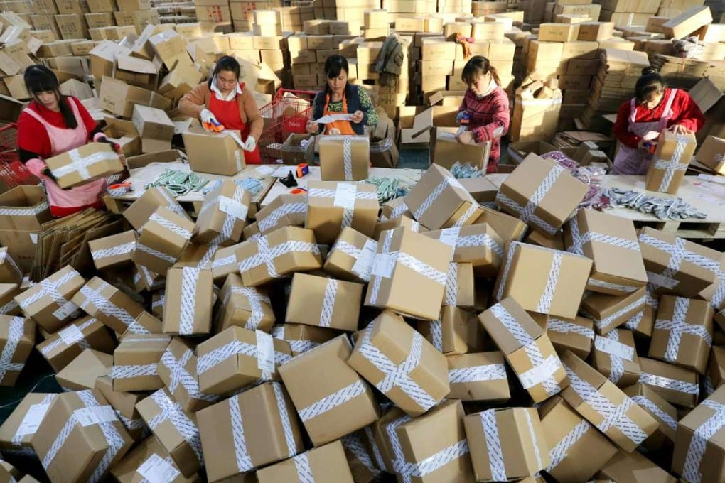Workers swamped by packages for delivery at a sorting centre in Lianyungang, Jiangsu province during the Singles’ Day online shopping event on November 11. Alibaba said 120.7 billion yuan was spent. Photo: AFP