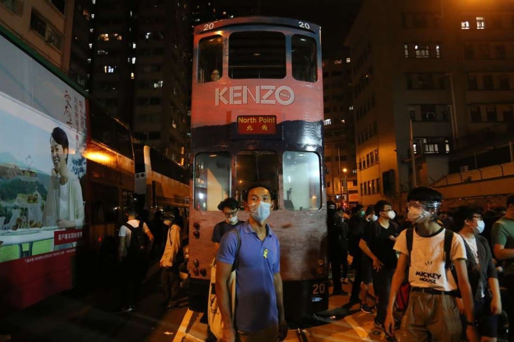 Protesters outside Western Police Station on Sunday evening in Hong Kong. There were repeated clashes between officers and protesters who had had broken off from an earlier, peaceful rally against Beijing's Basic Law interpretation over the Legco oath-taking row. Photo: AFP