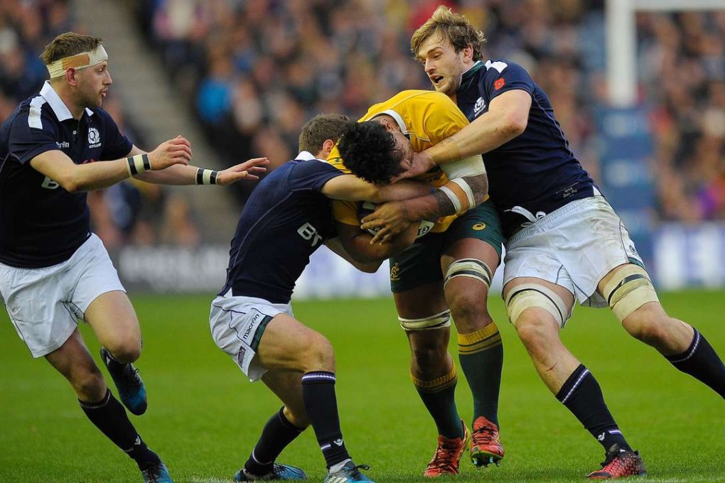 Australia's Lopeti Timani is tackled against Scotland at Murrayfield. Photo: AFP