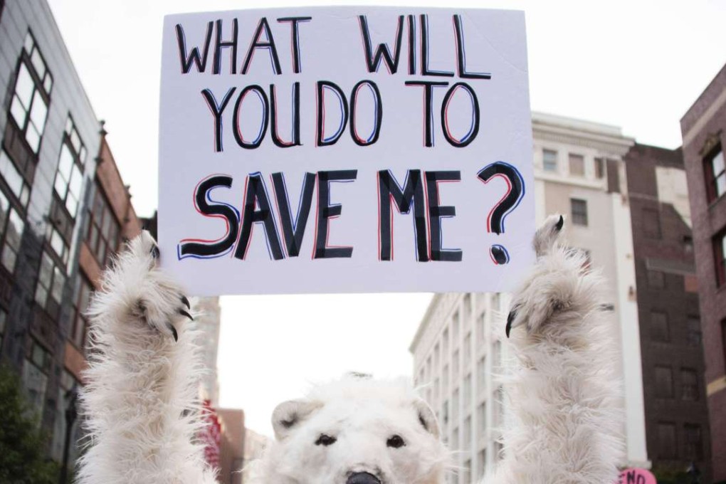 An environmental activist holds up a placard in Cleveland, Ohio, near the Republican National Convention site on July 18. Photo: AFP