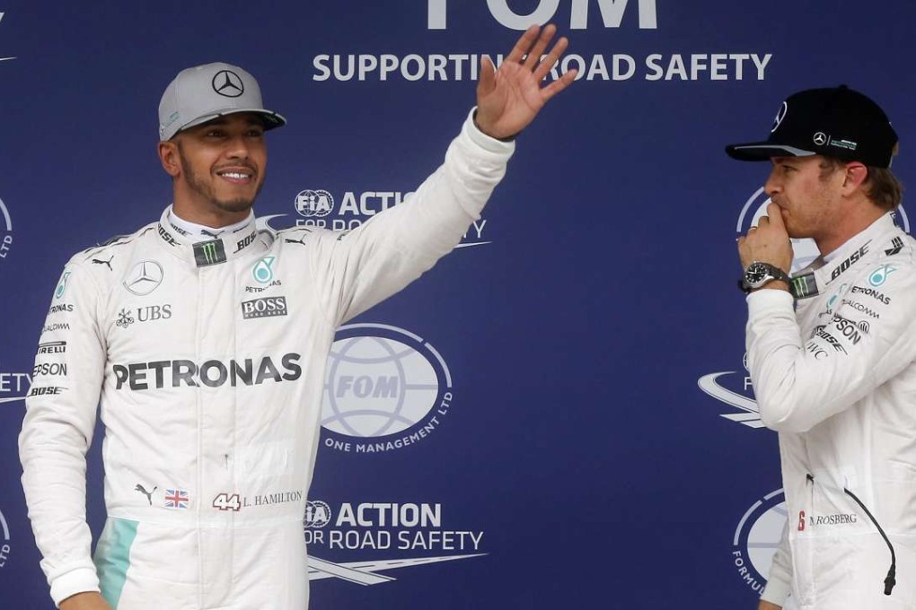 Britain’s Lewis Hamilton and German Nico Rosberg of Mercedes team on the podium after qualifying. Photo: EPA
