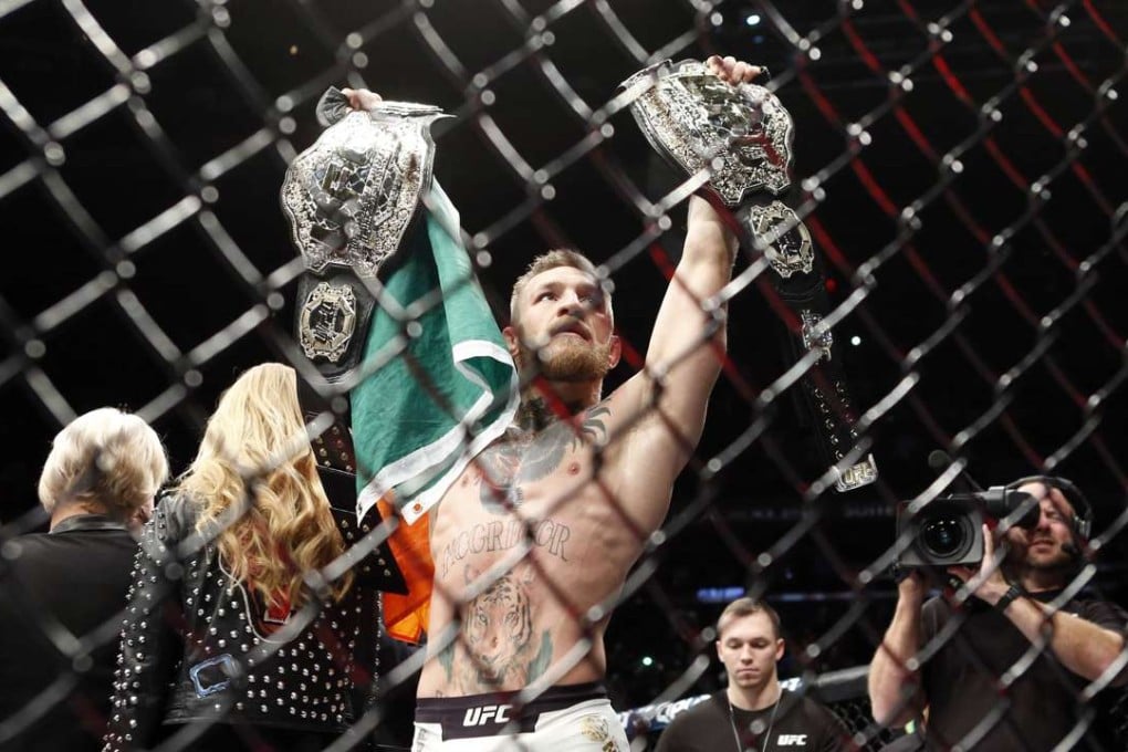 Conor McGregor celebrates with his two championship belts after defeating Eddie Alvarez in their lightweight title bout during UFC 205 at Madison Square Garden. Photo: USA Today