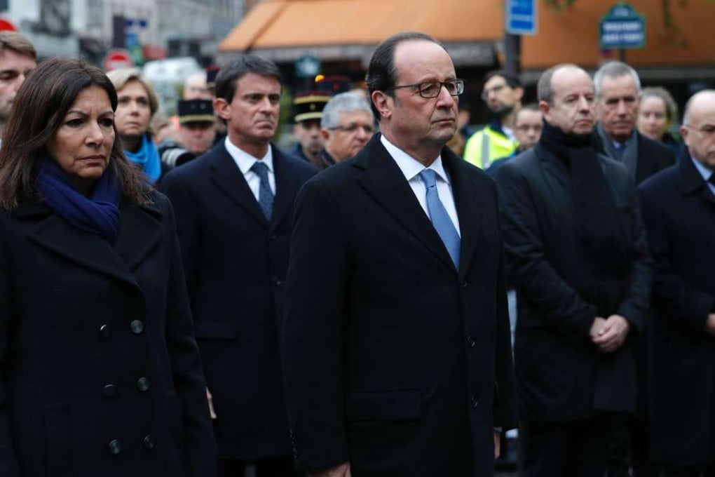 French President Francois Hollande with Paris Mayor Anne Hidalgo (left) after laying a wreath of flowers and unveiling a commemorative plaque at the scene of one of last year’s attacks in Pars. Photo: AFP