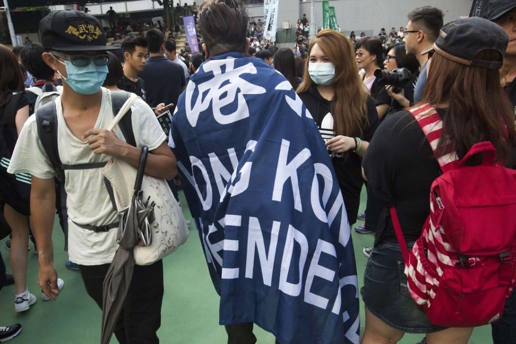A man drapes himself in a “Hong Kong Independence” flag during a protest against the Standing Committee’s interpretation of the Basic Law on lawmakers’ oath-taking. The alienation among the city’s young people towards the mainland and the growing appeal of separatism for them will not vanish with the ouster of the two localists from the legislature. Photo: EPA