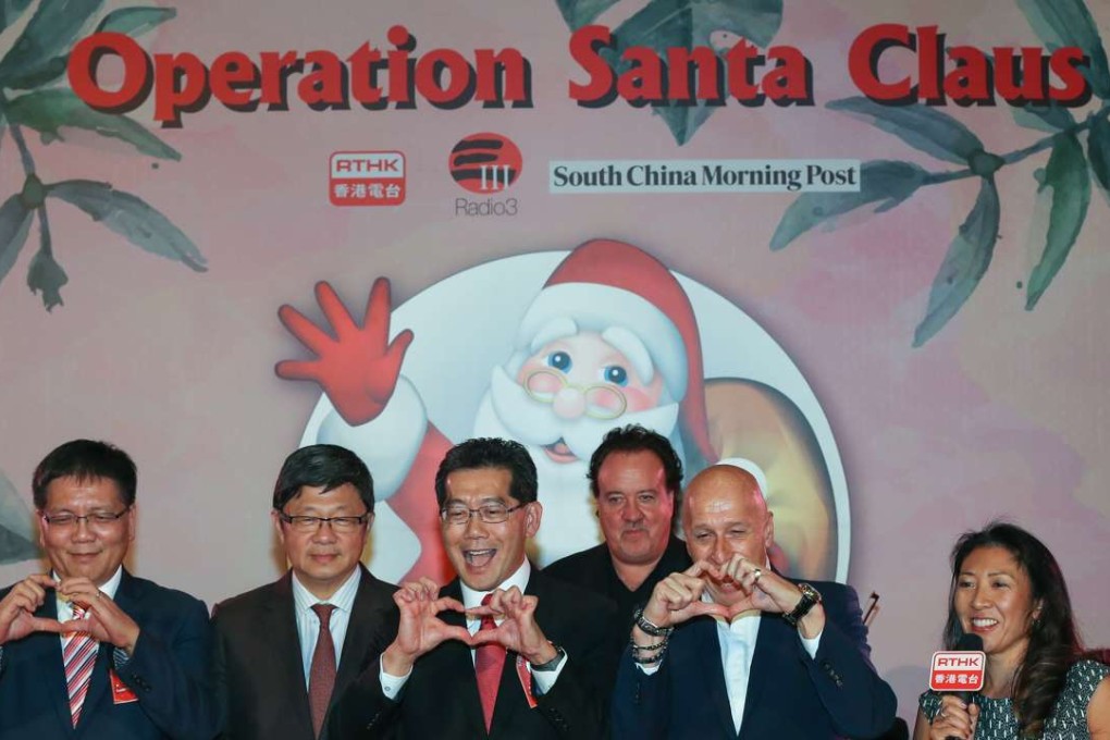 (From left) Leung Ka-wing, RTHK Director of Broadcasting; Robin Hu, CEO of SCMP; Gregory So Kam-leung, Secretary for Commerce and Economic Development and Allan Zeman attend the launch of Operation Santa Claus in Lan Kwai Fong. Photo: Nora Tam