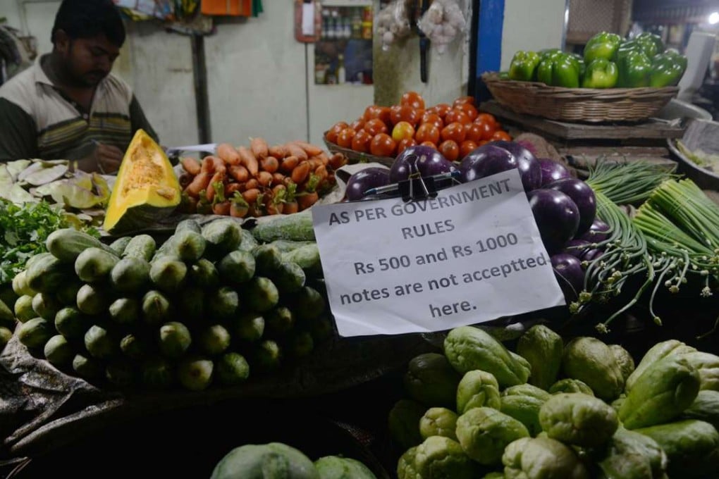 A vendor displays a sign relating to new nationwide currency regulations in Siliguri city, in the Indian state of West Bengal, on November 13. Photo: AFP