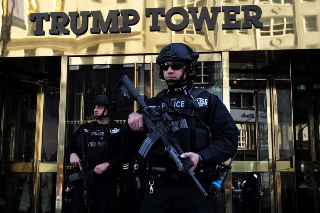 New York Police Department (NYPD) officers guard the main entrance of the Trump Tower, where US President-elect Donald Trump holds meetings, in New York on Monday. Photo: AFP