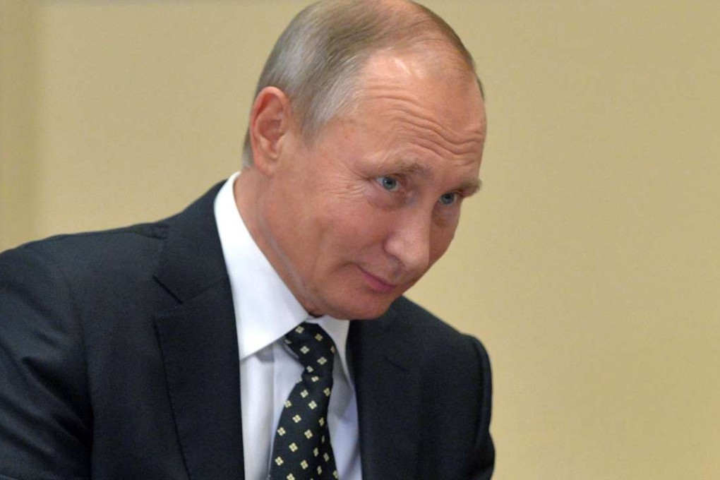 Russian President Vladimir Putin listens during a meeting in the Novo-Ogaryovo residence outside Moscow. Photo: AP