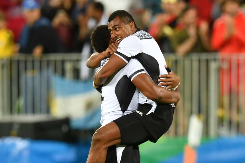 Fiji's players celebrate after winning the men's rugby sevens gold medal match between against Great Britain. Photo: AFP