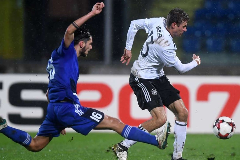 Germany’s Thomas Muller races away from San Marino’s Davide Cesarini during their 2018 World Cup group C qualifier at the Serravalle stadium in San Marino on Friday night. Photo: Xinhua