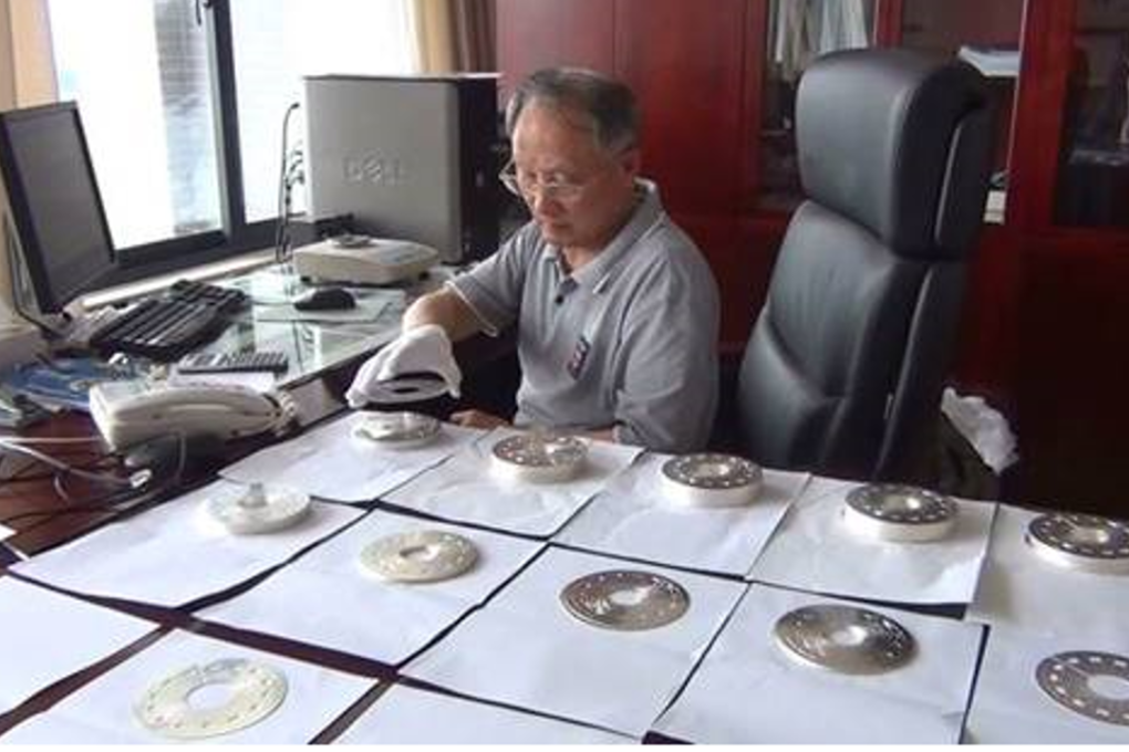 Professor Gao Bingjun examining critical parts of the super magnet. Credit: Chinese Academy of Sciences