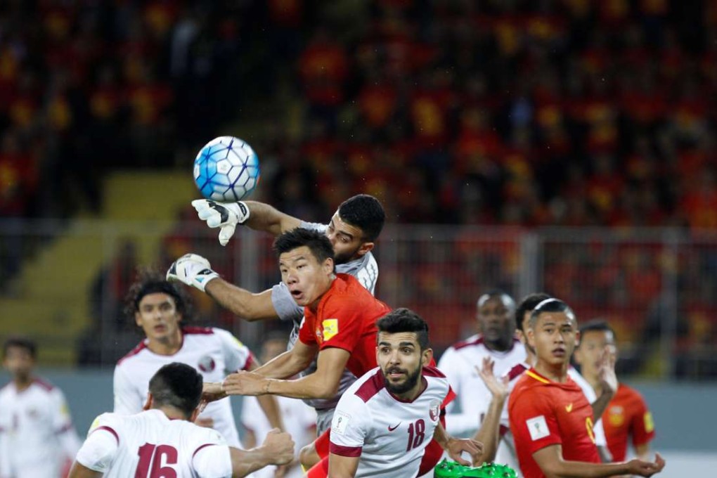 China’s Mei Fang challenges Qatar goalkeeper Saad Al-Sheeb. Photo: Reuters