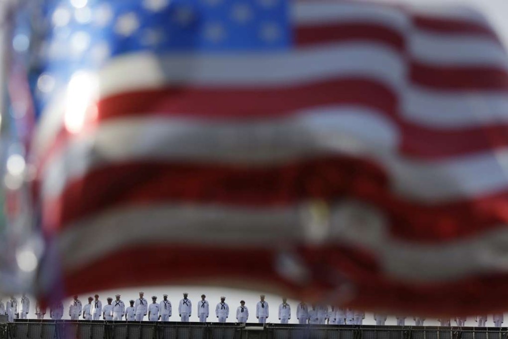 Sailors from the US Navy nuclear-powered aircraft carrier USS Ronald Reagan man the rails upon arrival in 2015 at the US Navy’s Yokosuka base, south of Tokyo, as US flag-shaped balloons are hoisted to welcome them. Photo: AP