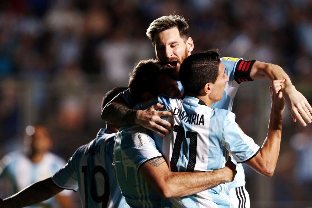 Argentina's Lucas Pratto (C) is embraced by teammates Lionel Messi and Angel Di Maria after he scored his team's second goal. REUTERS/Enrique Marcarian