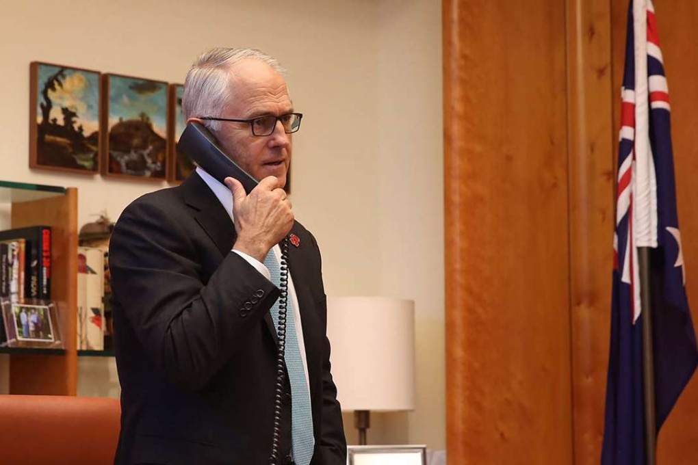 Australian Prime Minister Malcolm Turnbull talks on the phone to US President-elect Donald Trump. Photo: AFP