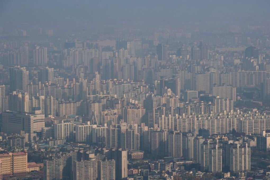 Buildings stand shrouded in haze in Daegu, South Korea. Photo: Bloomberg