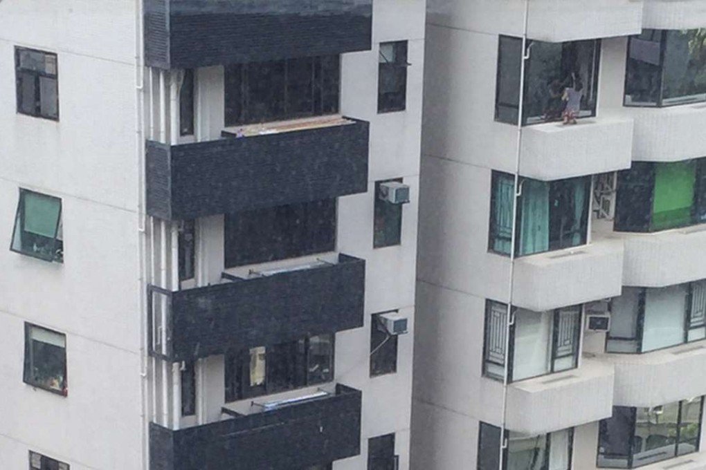 A domestic helper recently photographed cleaning windows at an apartment in the Silvercrest building, MacDonnell Road, Mid-Levels. Photo: SCMP Pictures