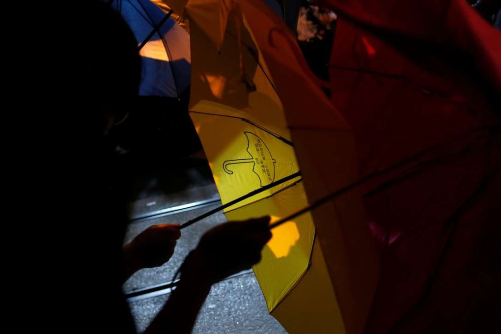 A yellow umbrella, symbol of the Occupy Central civil disobedience movement in Hong Kong, is seen as demonstrators confront police earlier this month during a protest against Beijing’s interpretation of the Basic Law. Photo: Reuters
