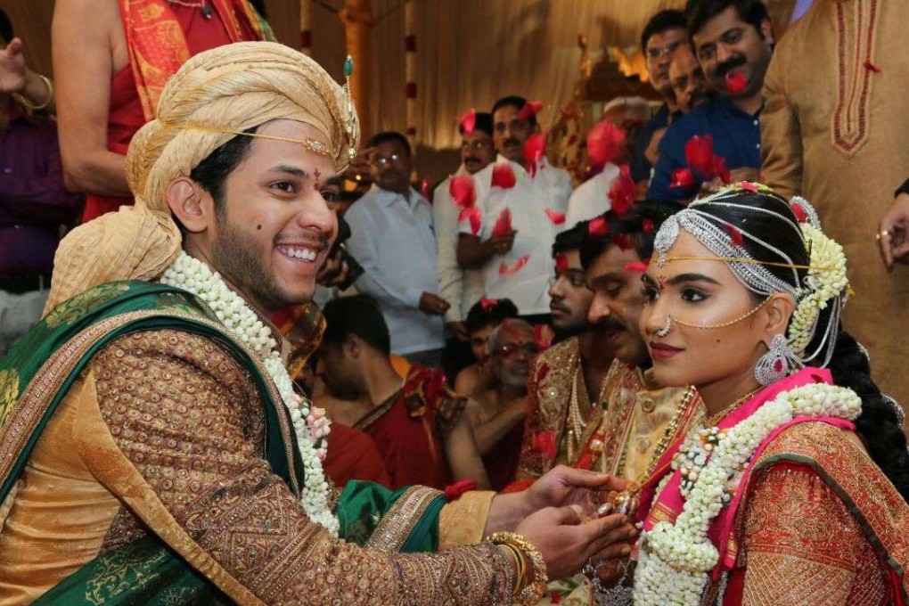 Daughter of Gali Janardhan Reddy, Bramhani (right) sits with her groom, Rajeev Reddy during their wedding at the Bangalore Palace Grounds in Bangalore. Photo: AFP/Janardhana Reddy family
