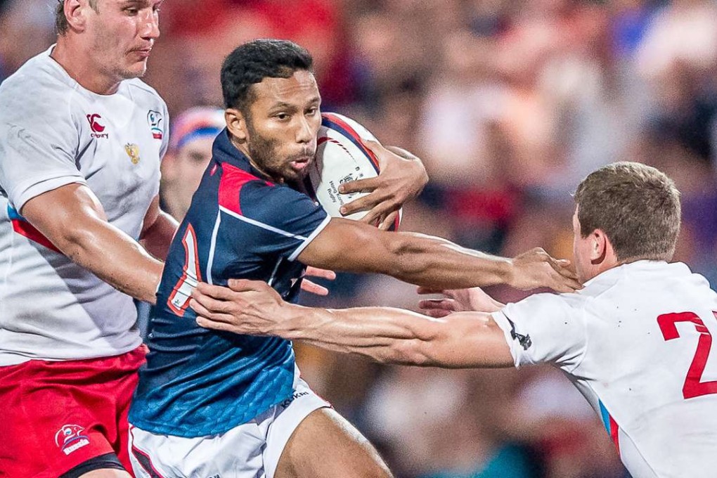 Upcoming Hong Kong scrum half Jason Jeyam is swamped in his side’s loss to Russia in the Cup of Nations. Photos: SCMP Pictures