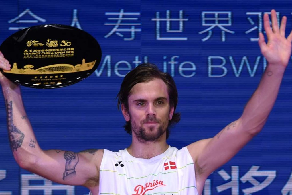 Jan O Jorgensen of Denmark celebrates on the podium after beating Chen Long to win the China Open in Fuzhou. Photo: Xinhua