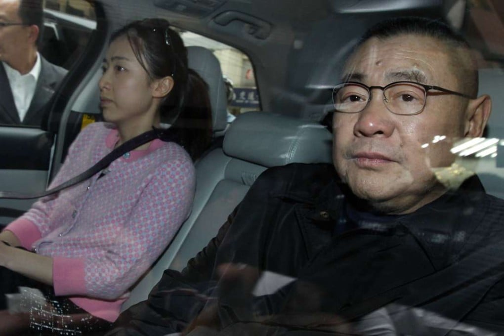 Joseph Lau leaves a Wan Chai restaurant with his girlfriend Chan Hoi-wan. Photo: Dickson Lee