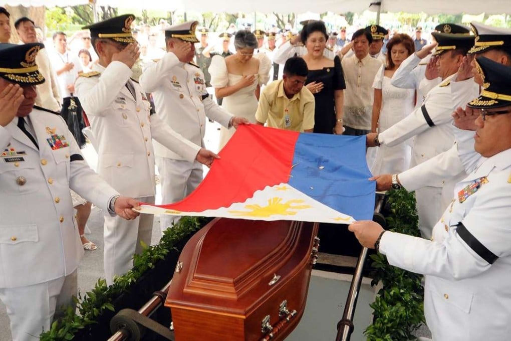 Members of the late dictator Ferdinand Marcos led by former first lady Imelda Marcos (in black) watch as military officers salute as they place a national flag at the coffin of the late president during the burial at the heroes' cemetery in Manila. Photo: AFP / Office of Governor Imee Marcos