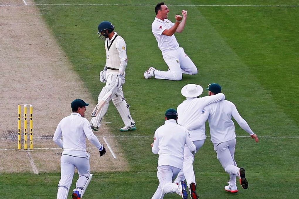 South Africa’s Kyle Abbott celebrates with teammates after taking the wicket of Australia’s Nathan Lyon to win an incredible match in Hobart. Photo: Reuters