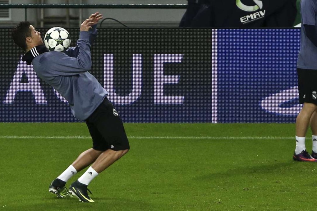 Cristiano Ronaldo juggles a ball during a training session at the Alvalade stadium in Lisbon ahead of their Uefa Champions League tie. Photo: EPA