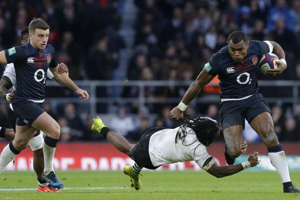 England's Semesa Rokoduguni (right) breaks through a tackle by Fiji's Albert Vulivuli. Photo: AP