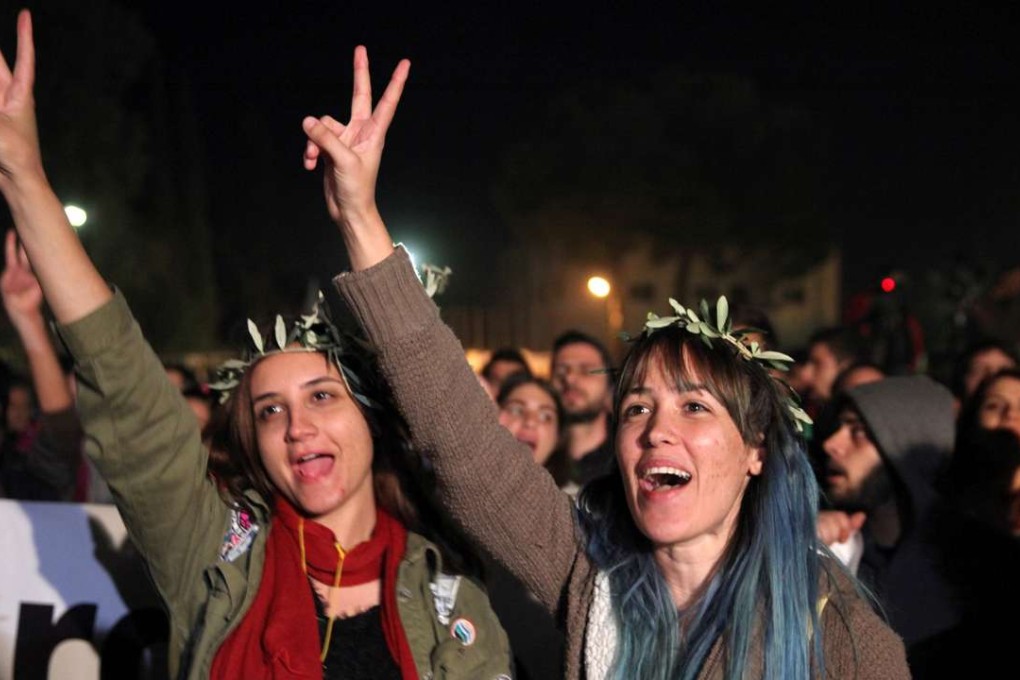 Greek Cypriots and Turkish Cypriots shouts slogans during a peace rally inside the UN-controlled buffer zone in Nicosia on Monday amid talks on the future of the island. Photo: Reuters