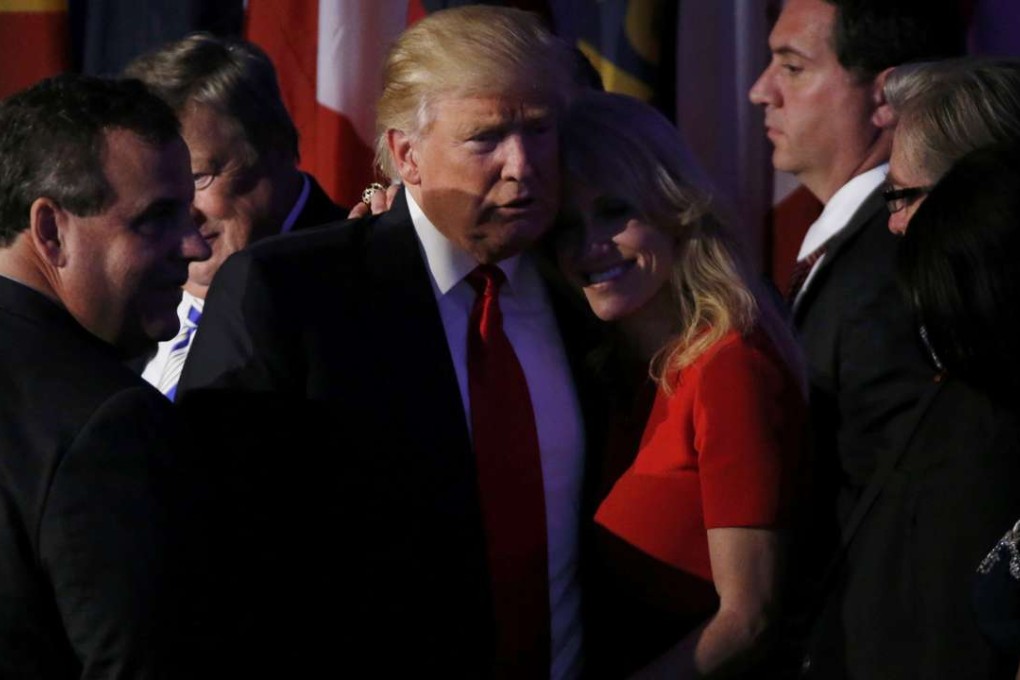 US President-elect Donald Trump hugs campaign manager Kellyanne Conway as he stands between Governor Chris Christie (L) and campaign CEO Stephen Bannon (R) at his election night rally in Manhattan. Photo: Reuters