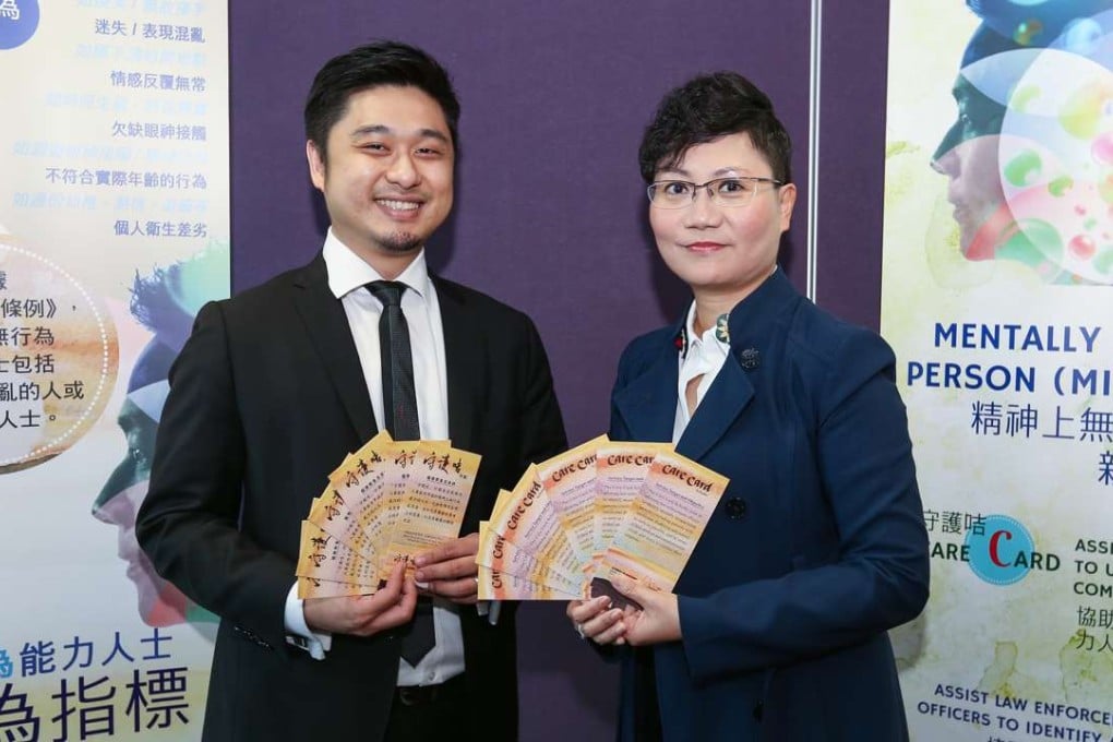 Michael Fung, police clinical psychologist and Irene Ho Yuen-ha, police chief superintendent display special cards to be issued to the mentally disabled. Photo: Xiaomei Chen