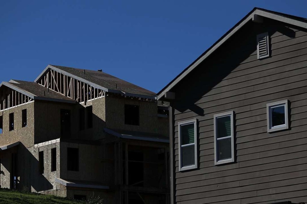 A home under construction stands next to a newly built home at a new housing development in Petaluma, California. Photo: AFP