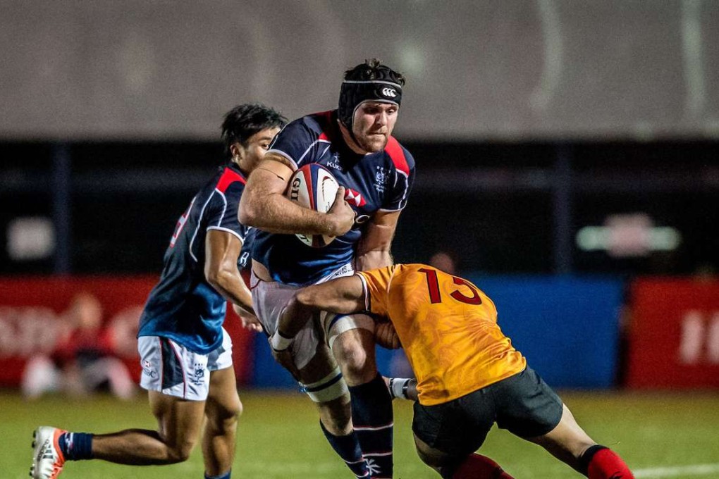 Dan Falvey takes on a tackler in Hong Kong’s win over Papua New Guinea in the Cup of Nations. Photo: SCMP Pictures