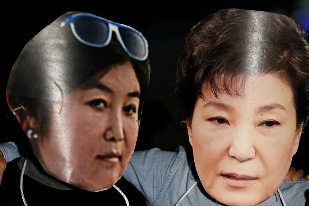 Protesters wearing cut-outs of South Korean President Park Geun-hye (right) and Choi Soon-sil. Photo: Reuters