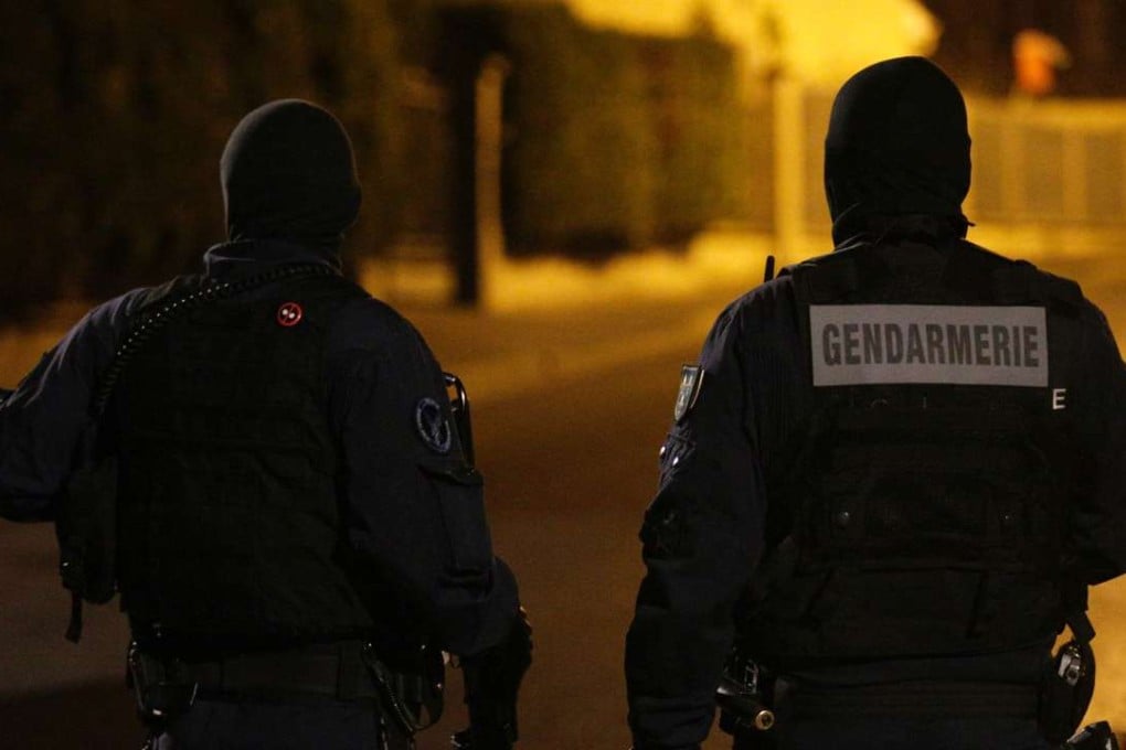 Police stand on a street after clashes with protesters in Beaumont-sur-Oise, north of Paris on Wednesday. Photo: AFP