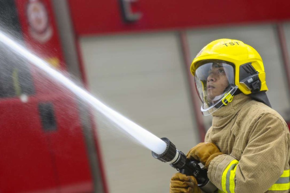 Shakir Mohammad tests a hose at Tseung Kwan O fire station. The Pakistan-born 25-year-old passed the recruitment tests at the third attempt. Photo: Xiaomei Chen