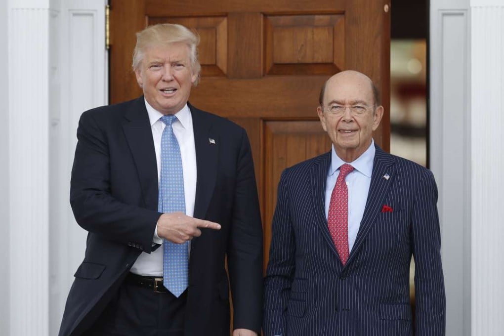 US President-elect Donald Trump poses stands with investor Wilbur Ross after meeting at the Trump National Golf Club Bedminster clubhouse in New Jersey on Sunday. Photo: AP