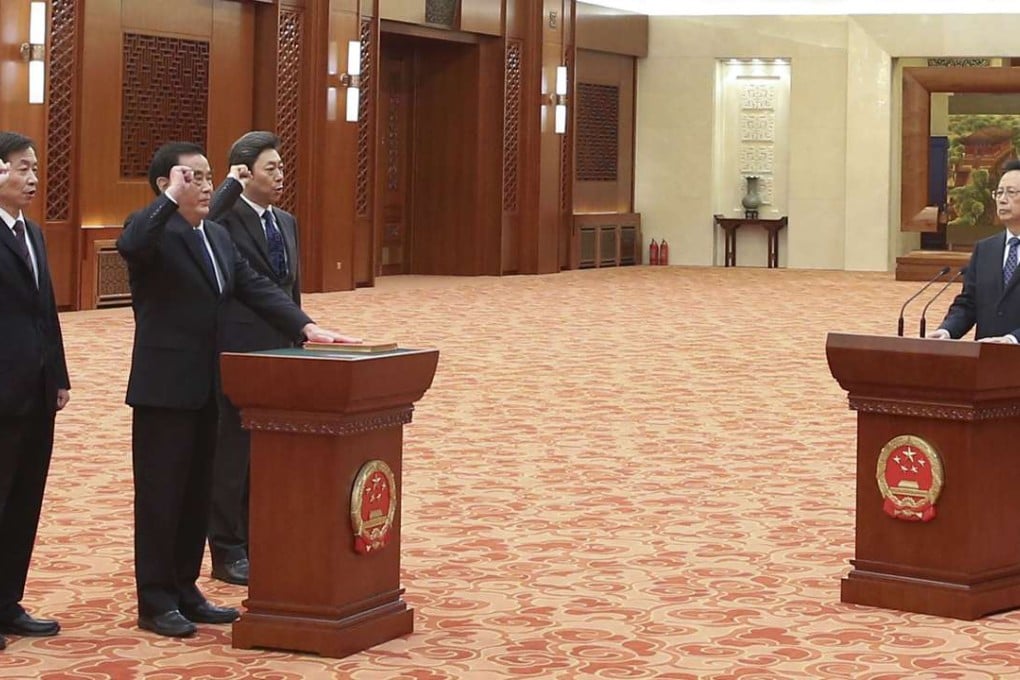 National People’s Congress Standing Committee vice-chairman Chen Changzhi (right) presides over an oath-taking ceremony for (from left) Minister of Civil Affairs Huang Shuxian, NPC financial and economic affairs committee vice-chairman Sheng Guangzu and Minister of State Security Chen Wenqing at the Great Hall of the People in Beijing on November 7. Photo: Xinhua