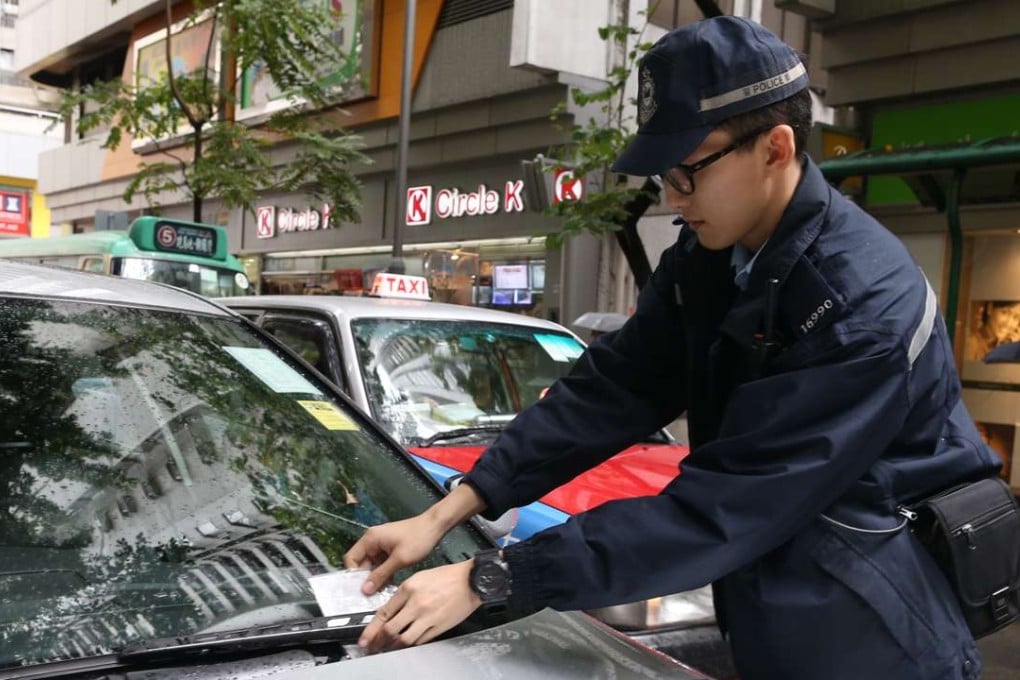 Another ticket is dispensed, while the daily chaos continues unabated. Photo: Dickson Lee