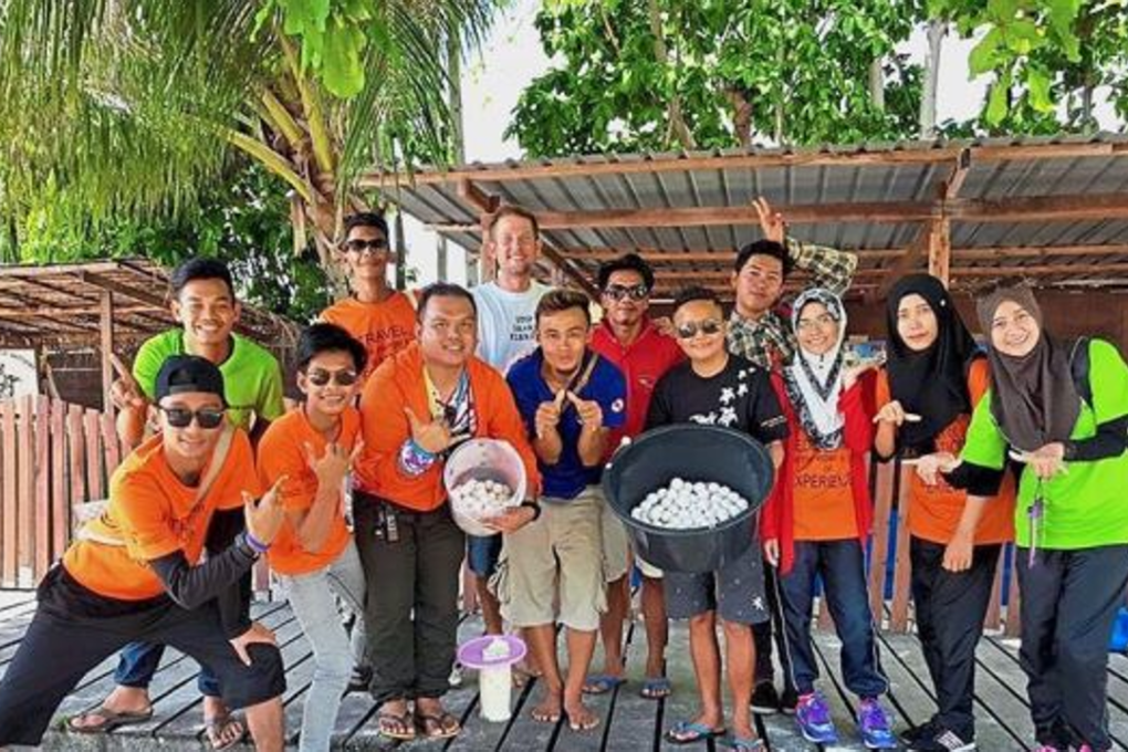 Egg-straordinary individuals: Kolej Komuniti students with honorary wildlife wardens at the Pulau Mabul turtle hatchery. Photo: The Star Online